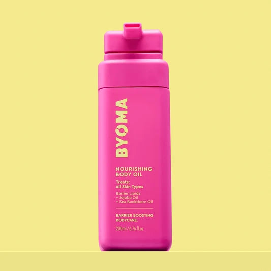 Byoma Nourishing Body Oil dans un flacon rose vif.